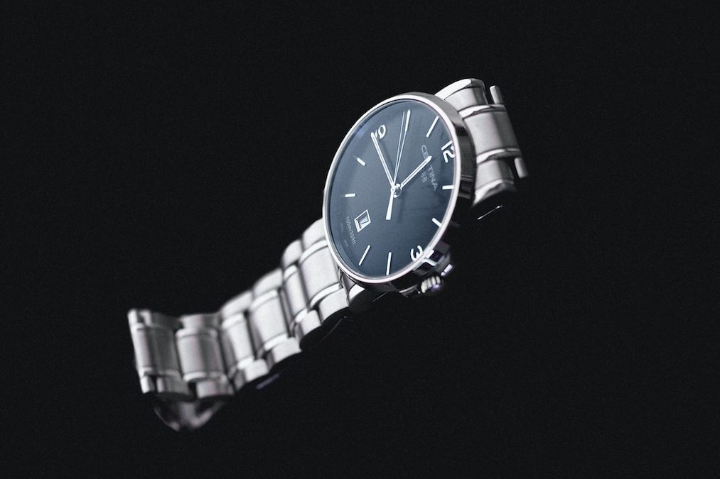 round silver-colored analog watch with link band